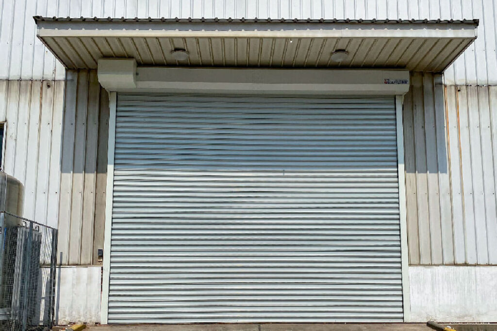 Steel rolling shutter installed at an industrial building opening