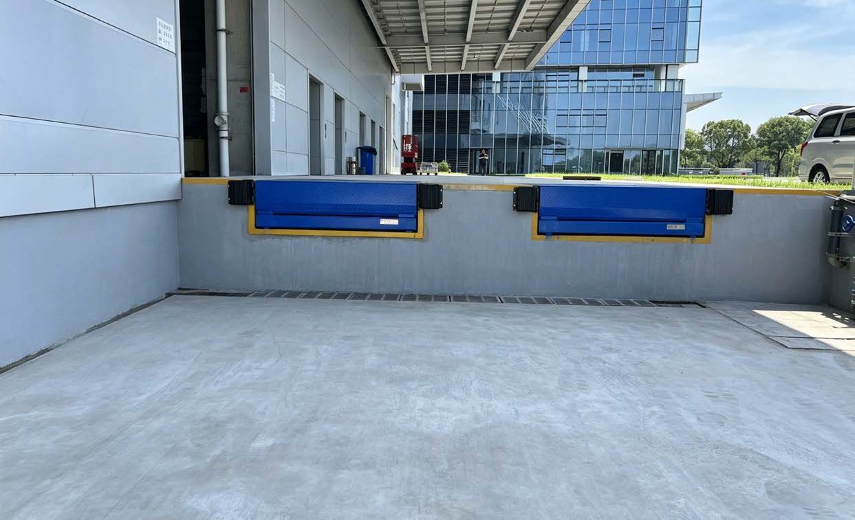 Blue hydraulic dock levelers installed at a modern industrial loading bay