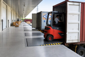Loading dock automation with dock leveler and automated warehouse system