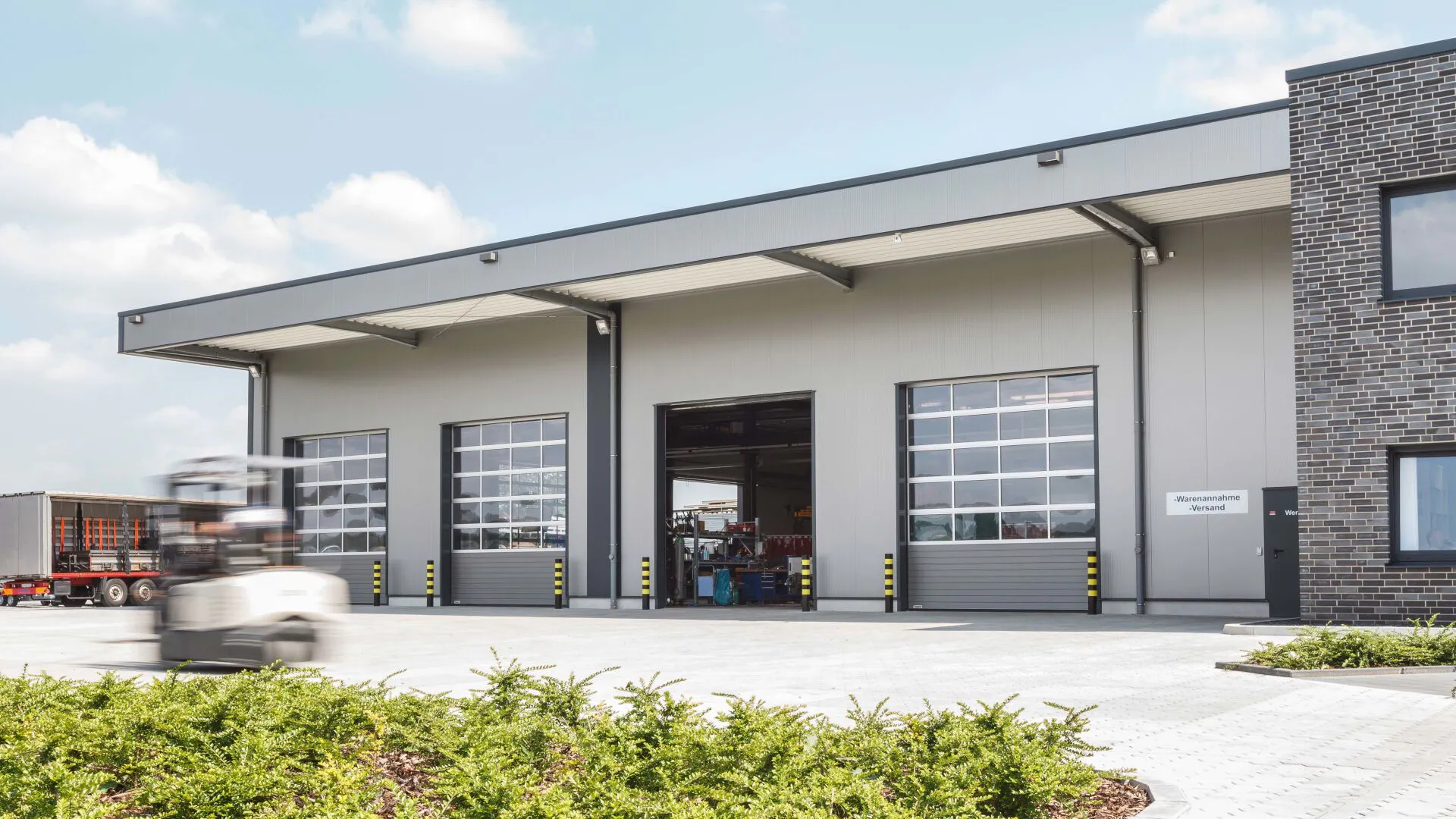 Commercial sectional overhead doors at an industrial warehouse and logistics facility